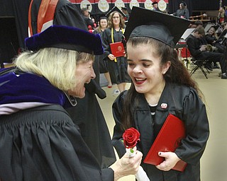 William D. Lewis the Vindicator Madison Goske of Canfield gets a rose from one of her professors Dr. Thelma Silver during 12132015 commencement. Goske 's degree was  bachelor of social work.