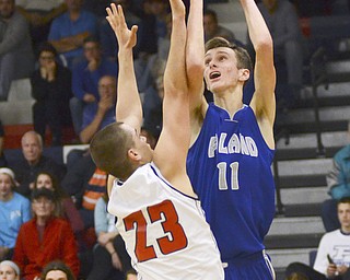 Katie Rickman | The Vindicator.Poland's Matt Baker (#11) shoots a basket and scores against Fitch's Dom DiFrancesio (SPELLING?) (#23) during the fourth period of the game at Fitch High School on Tuesday night.
