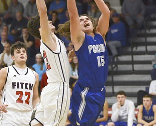 Katie Rickman | The Vindicator.Poland's Nick Bucieri (#15) shoots a basket and scores against Fitch's Brian Beany (#33) during the fourth period of the game at Fitch High School on Tuesday night.