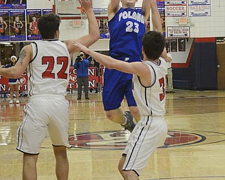 Katie Rickman | The Vindicator.Poland's Jared Burkert (#23) shoots a basket but is blocked by Fitch's Brian Beany (#33) and Derek Gunter(#22)  during the second period of the game at Fitch High School on Tuesday night.