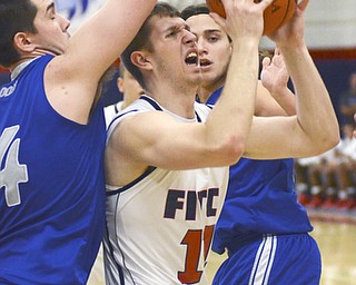 Katie Rickman | The Vindicator. Fitch's Anthony Pengio (SPELLING?) (#11) is boxed in by Poland's Jacob Burns (#14) as he shoots and scores during the first period of the game at Fitch High School on Tuesday night.