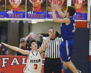 Katie Rickman | The Vindicator.Poland's Mike Bojdos (#3) as he shoots over the head of Fitch's Scotty Duffy (#3) and scores during the third period of the game at Fitch High School on Tuesday night.