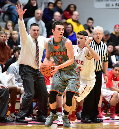 LEAVITTSBURG, OHIO - DECEMBER 22, 2015: Jaden Walton #3 of Newton Falls attempts to find a teammate to pass the ball to while being pressured from behind by Jason Downey #23 of Labrae during the 1st half of their game Tuesday night at Labrae High School. DAVID DERMER | THE VINDICATOR
