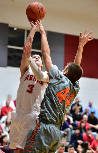 LEAVITTSBURG, OHIO - DECEMBER 22, 2015: Grant Sprague #3 of Labrae puts up a shot over Vince Dragich #44 of Newton Falls during the 1st half of their game Tuesday night at Labrae High School. DAVID DERMER | THE VINDICATOR