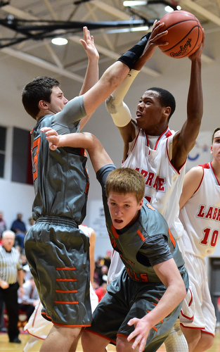 LEAVITTSBURG, OHIO - DECEMBER 22, 2015: Tariq Drake #14 of Labrae looks to put up a shot after grabbing a rebound over Alan Boone #23 and Joey Urso #23 of Newton Falls during the 1st half of their game Tuesday night at Labrae High School. DAVID DERMER | THE VINDICATOR