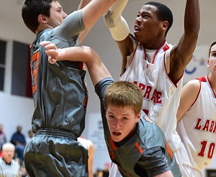 LEAVITTSBURG, OHIO - DECEMBER 22, 2015: Tariq Drake #14 of Labrae looks to put up a shot after grabbing a rebound over Alan Boone #23 and Joey Urso #23 of Newton Falls during the 1st half of their game Tuesday night at Labrae High School. DAVID DERMER | THE VINDICATOR