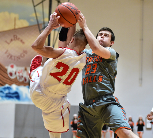 LEAVITTSBURG, OHIO - DECEMBER 22, 2015: Alan Boone #23 of Newton Falls attempts to rip the ball out of the hands of Benton Tennant #20 of Labrae during the 1st half of their game Tuesday night at Labrae High School. DAVID DERMER | THE VINDICATOR