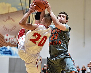 LEAVITTSBURG, OHIO - DECEMBER 22, 2015: Alan Boone #23 of Newton Falls attempts to rip the ball out of the hands of Benton Tennant #20 of Labrae during the 1st half of their game Tuesday night at Labrae High School. DAVID DERMER | THE VINDICATOR