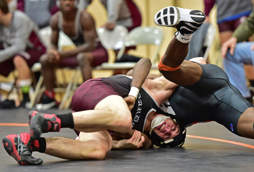HOWLAND, OHIO - DECEMBER 23, 2015: Carlo DeNiro of Boardman works to flip Cross Scarpaci of Howland over onto his back during a 160lb bout Wednesday afternoon at Howland High School. DAVID DERMER | THE VINDICATOR