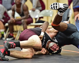 HOWLAND, OHIO - DECEMBER 23, 2015: Carlo DeNiro of Boardman works to flip Cross Scarpaci of Howland over onto his back during a 160lb bout Wednesday afternoon at Howland High School. DAVID DERMER | THE VINDICATOR