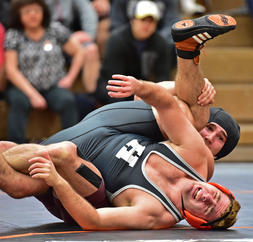 HOWLAND, OHIO - DECEMBER 23, 2015: Tyler Dempsey of Boardman attempts to work Michael Fitzpatrick of Howland to his back during a 170lb bout Wednesday afternoon at Howland High School. DAVID DERMER | THE VINDICATOR