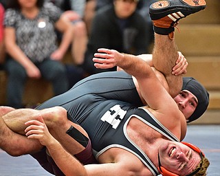 HOWLAND, OHIO - DECEMBER 23, 2015: Tyler Dempsey of Boardman attempts to work Michael Fitzpatrick of Howland to his back during a 170lb bout Wednesday afternoon at Howland High School. DAVID DERMER | THE VINDICATOR
