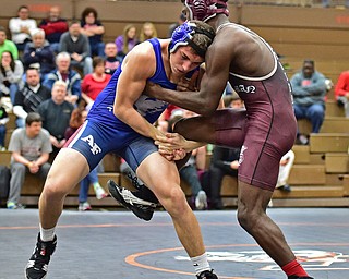 HOWLAND, OHIO - DECEMBER 23, 2015: AJ Stehura of Fitch grabs the leg of Kelly Williams of Boardman during a 152lb bout Wednesday afternoon at Howland High School. DAVID DERMER | THE VINDICATOR