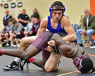 HOWLAND, OHIO - DECEMBER 23, 2015: AJ Stehura of Fitch works to isolate the arm of Kelly Williams of Boardman during a 152lb bout Wednesday afternoon at Howland High School. DAVID DERMER | THE VINDICATOR