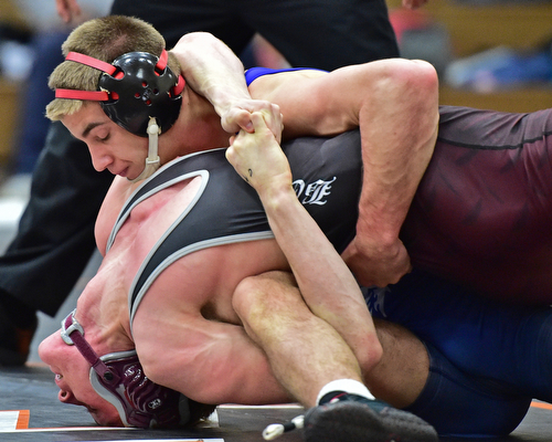 HOWLAND, OHIO - DECEMBER 23, 2015: Carlo DeNiro of Boardman attempts keep his shoulders off the mat while  Adam Green of Fitch goes for the pin during a 160lb bout Wednesday afternoon at Howland High School. DAVID DERMER | THE VINDICATOR