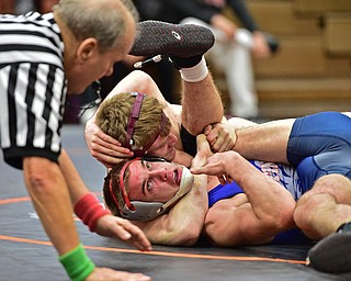 HOWLAND, OHIO - DECEMBER 23, 2015: Adam Green of Fitch looks to the referee while his counts points while he attempts to avoid being pinned by Carlo DeNiro of Boardman during a 160lb bout Wednesday afternoon at Howland High School. DAVID DERMER | THE VINDICATOR