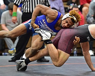HOWLAND, OHIO - DECEMBER 23, 2015: Isiah Jackson of Fitch grabs the leg of Tyler Dempsey of Boardman while the two go to the mat during a 160lb bout Wednesday afternoon at Howland High School. DAVID DERMER | THE VINDICATOR