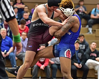 HOWLAND, OHIO - DECEMBER 23, 2015: Isiah Jackson of Fitch attempts to kick out the leg of Tyler Dempsey of Boardman during a 160lb bout Wednesday afternoon at Howland High School. DAVID DERMER | THE VINDICATOR