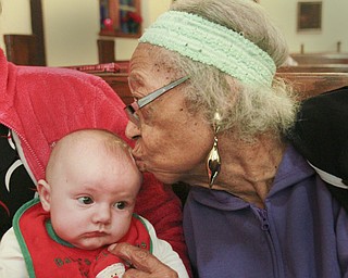 William D. Lewis the Vindicator Ella Robinson,97, of Youngstown and longtime member of St. Augustine Episcopal Church in Youngstown shares a moment with 3month old Kaylee Stuckey who was attending the seervice with her mother Julia Willis of Youngstown.