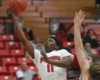 William D Lewis The Vindicator  YSU's Latin davis(11) scores past Milwaukee's Cody Wichmann(5)  Thursday 1-7-16 .