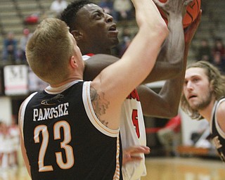 William D Lewis The Vindicator  YSU's Sidney Umude(5) shoots past Milwaukee's JJ Panoske(23).