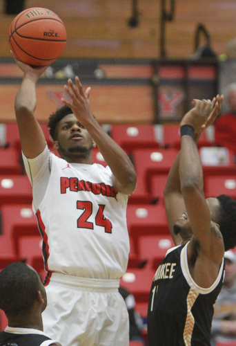 William D Lewis The Vindicator YSU's Cameron Morse(24) shoots past Milwaukee's JayQuan McCLoud(11).