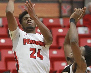 William D Lewis The Vindicator YSU's Cameron Morse(24) shoots past Milwaukee's JayQuan McCLoud(11).