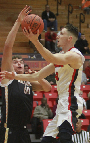 William d Lewis the Vindicator YSU's Matt Donlin(0) shoots past Milwaukee's Brett Prahl(50).