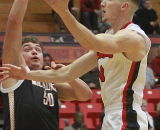 William d Lewis the Vindicator YSU's Matt Donlin(0) shoots past Milwaukee's Brett Prahl(50).