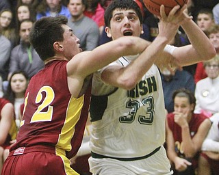 William D Lewis The Vindicator t Ursuline's Armon Nasseri(33) tries to shoot past Mooney's Andrew Armstrong(12)