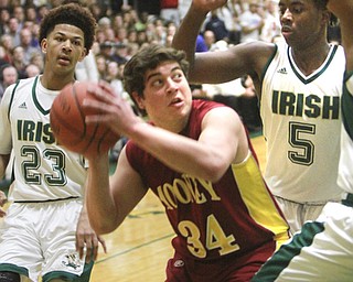 William D Lewis The Vindicator Mooney's Vinnie Gentile(34) is hemmed in by Ursuline's Chris Hughes(23) qand Anthony Howell(5)