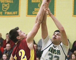 William D Lewis The Vindicator t Ursuline's Armon Nasseri(33) tries to shoot past Mooney's Andrew Armstrong(12).