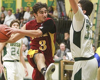 William D Lewis The Vindicator Mooney's Nicholas Koken(3) drives past Ursuline's Armon Nasseri(33)