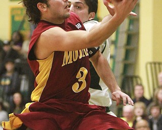 William D Lewis The Vindicator Mooney's Nicholas Koken(3) drives past Ursuline's Armon Nasseri(33)