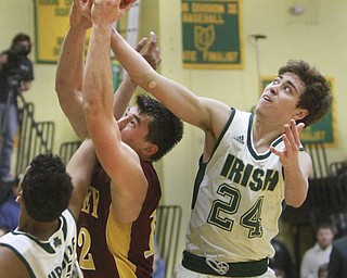 William D Lewis The Vindicator  Mooney's Andrew Armstrong(12) fights for a rebound with Ursuline's Devin Harden(10), left and Greg Parella(24) during 1-8-16 game at Ursuline.