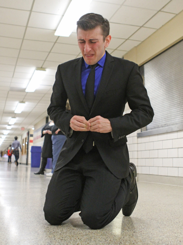 Gino Ginetti of Cardinal Mooney High School drops to his knees as he runs through his dramatic speech in the cafeteria of Canfield High School during a Speech and Debate competition on Saturday morning.  Dustin Livesay  |  The Vindicator  1/9/16  Canfield.