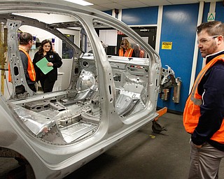       .   ROBERT K. YOSAY  | THE VINDICATOR..Michele Lambert  and Mike Polder  look over the weld inspection station....  as he finishes up a test on the welds of the new 2016- GM Lordstown - as it ramps up to the New Generation Cruise 2016 in February....--30-...