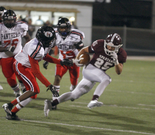 ROBERT  K. YOSAY | THE VINDICATOR
Boardman at Harding: Boardman's #25 makes a cut away from Harding's #11 Chris Clarke with #19 Gen Gonzalez during second quarter action as he breaks around end.