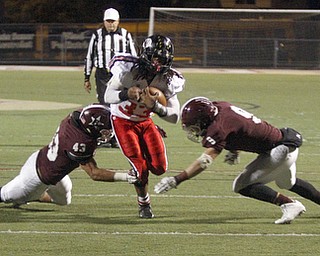 ROBERT  K. YOSAY | THE VINDICATOR
Boardman at Harding: Harding's #33 Keemari Murry tries to break the grasp of Boardman's #43 Erick Ritz and #9 Gaens Strines.