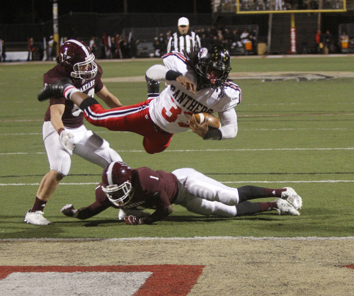 ROBERT  K. YOSAY | THE VINDICATOR
Boardman at Harding: Harding's #33 Keemari Murry Leaps into the end zone for their first score as Boardman's #1 Koby Adu-Poku on the ground and #60 look on.