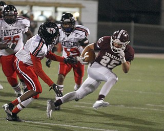 ROBERT  K. YOSAY | THE VINDICATOR
Boardman at Harding: Boardman's #25 makes a cut away from Harding's #11 Chris Clarke with #19 Gen Gonzalez during second quarter action as he breaks around end.
