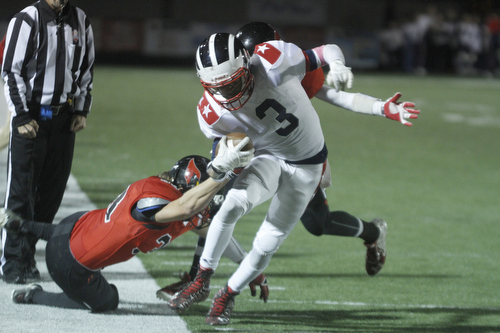 ROBERT  K. YOSAY | THE VINDICATOR
Niles at Canfield: Niles #3 Jason Faison tries to turn the ball upfield during third quarter action as Canfield's #33 Eugene Calabria and #2 Vinny Florenza bring him down.