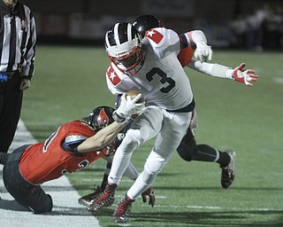 ROBERT  K. YOSAY | THE VINDICATOR
Niles at Canfield: Niles #3 Jason Faison tries to turn the ball upfield during third quarter action as Canfield's #33 Eugene Calabria and #2 Vinny Florenza bring him down.