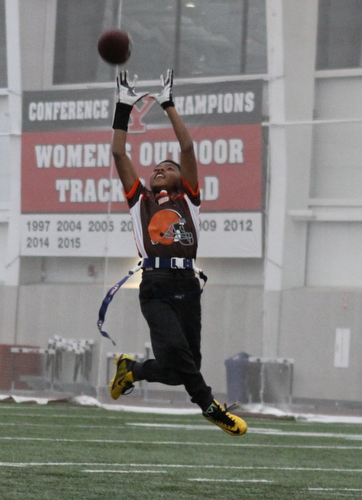 Nasir Okane stretches to make a catch during practice for the 9-10 year old YYFFA team on Wednesday night at the WATTS.  Dustin Livesay  |   The Vindicator  1/13/16  YSU, WATTS