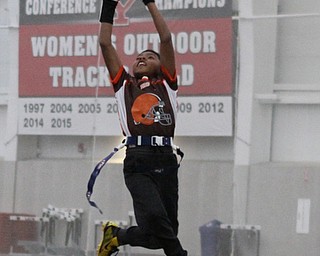 Nasir Okane stretches to make a catch during practice for the 9-10 year old YYFFA team on Wednesday night at the WATTS.  Dustin Livesay  |   The Vindicator  1/13/16  YSU, WATTS