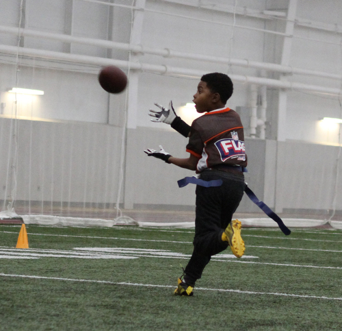 Nasir Okane makes a catch during practice for the 9-10 year old YYFFA team on Wednesday night at the WATTS.  Dustin Livesay  |   The Vindicator  1/13/16  YSU, WATTS