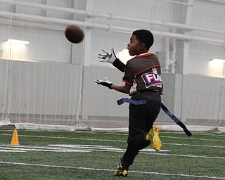 Nasir Okane makes a catch during practice for the 9-10 year old YYFFA team on Wednesday night at the WATTS.  Dustin Livesay  |   The Vindicator  1/13/16  YSU, WATTS