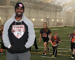 President of the Youngstown Youth Flag Football Association, Elliot Giles, poses for a picture while .his teams stretch during practice on Wednesday night at the WATTS.  Dustin Livesay  |   The Vindicator  1/13/16  YSU, WATTS