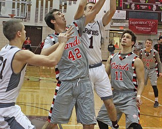 Canfield's Sam Digiacomo (42) knocks the ball out of the hands of Boardman's John Ryan (1) while he went up for a shot during the second quarter of Friday nights matchup at Boardman High School.  Dustin Livesay  |  The Vindicator  1/22/16  Boardman High School.