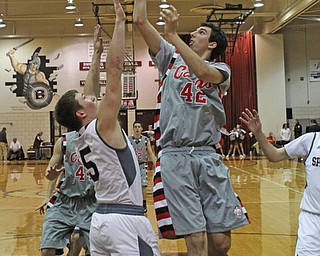 Canfield's Sam Digiacomo (42) puts up a shot while being defended by Boardman's Alex Duda (5) during the second quarter of Friday nights matchup at Boardman High School.  Dustin Livesay  |  The Vindicator  1/22/16  Boardman High School.
